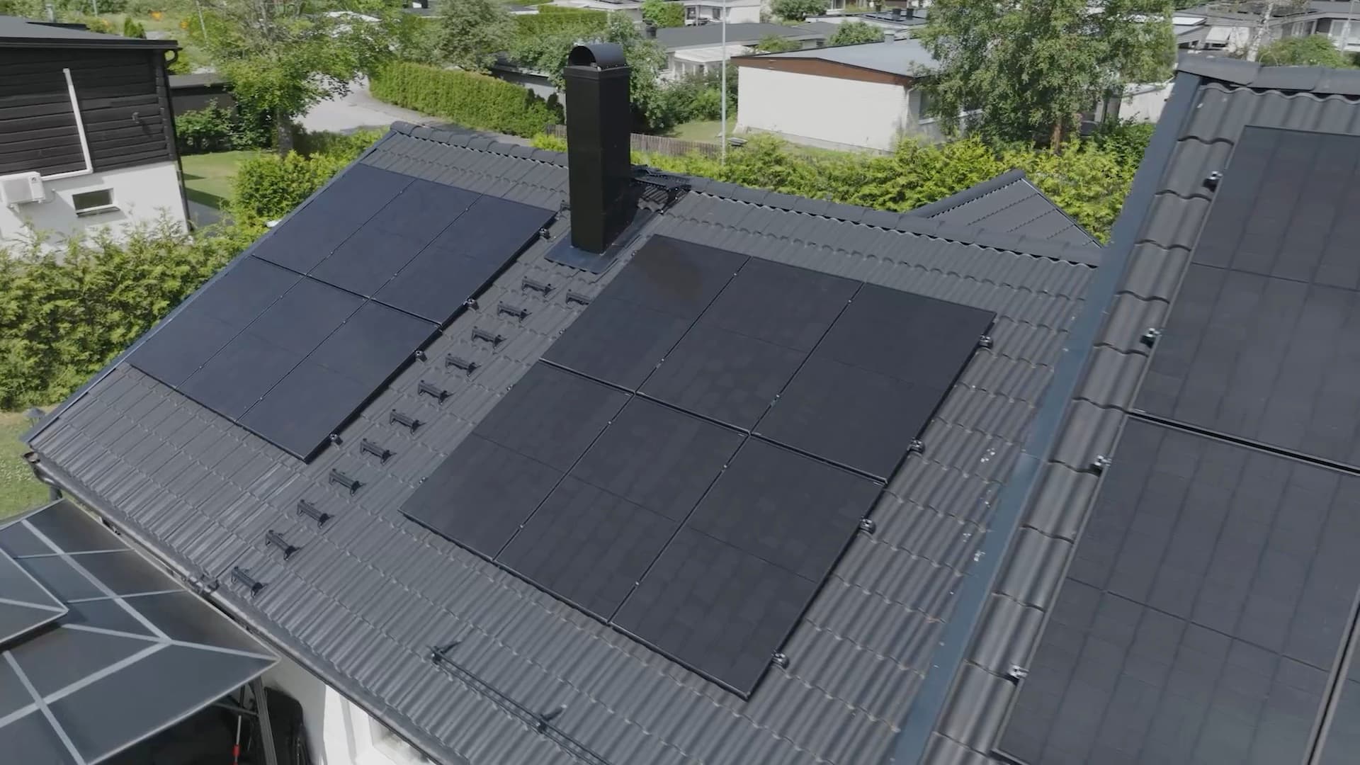 Aerial view of Elvy solar panels on a house roof in summer sun