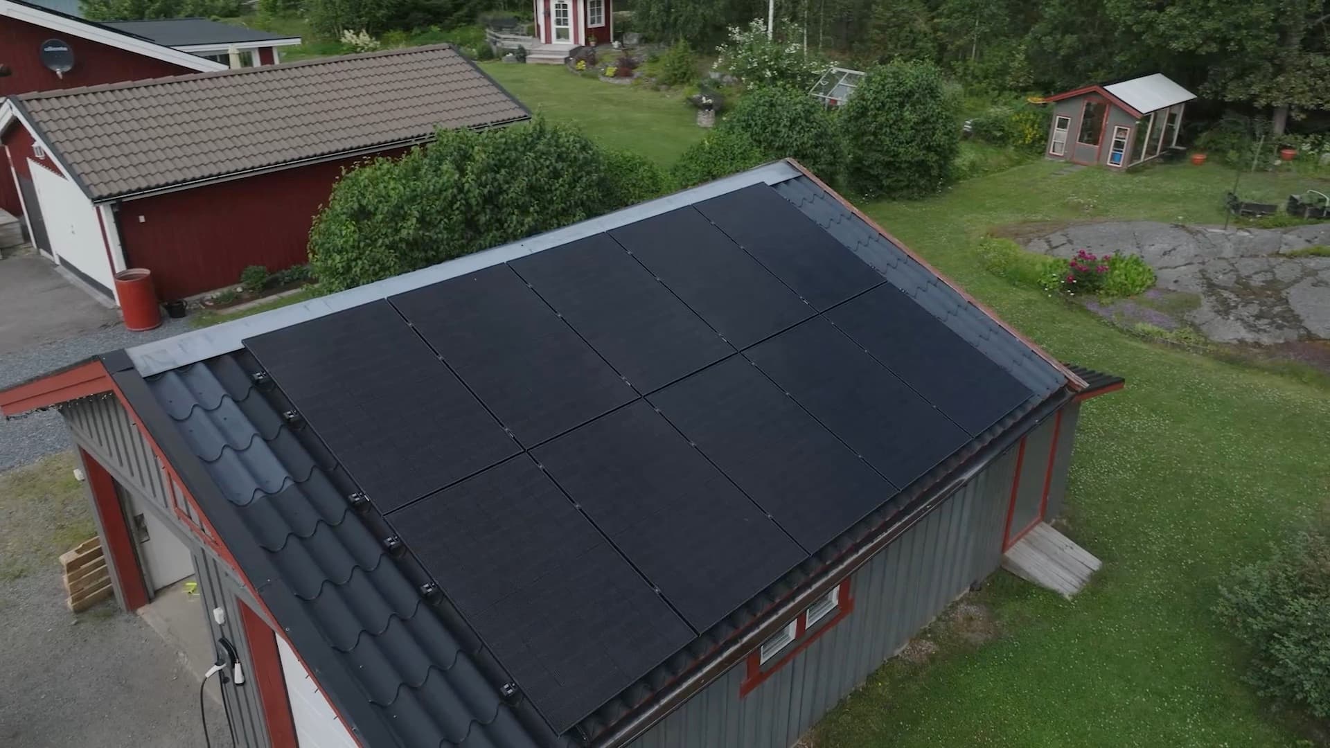 Aerial view of a house with Elvy solar panels on the garage roof