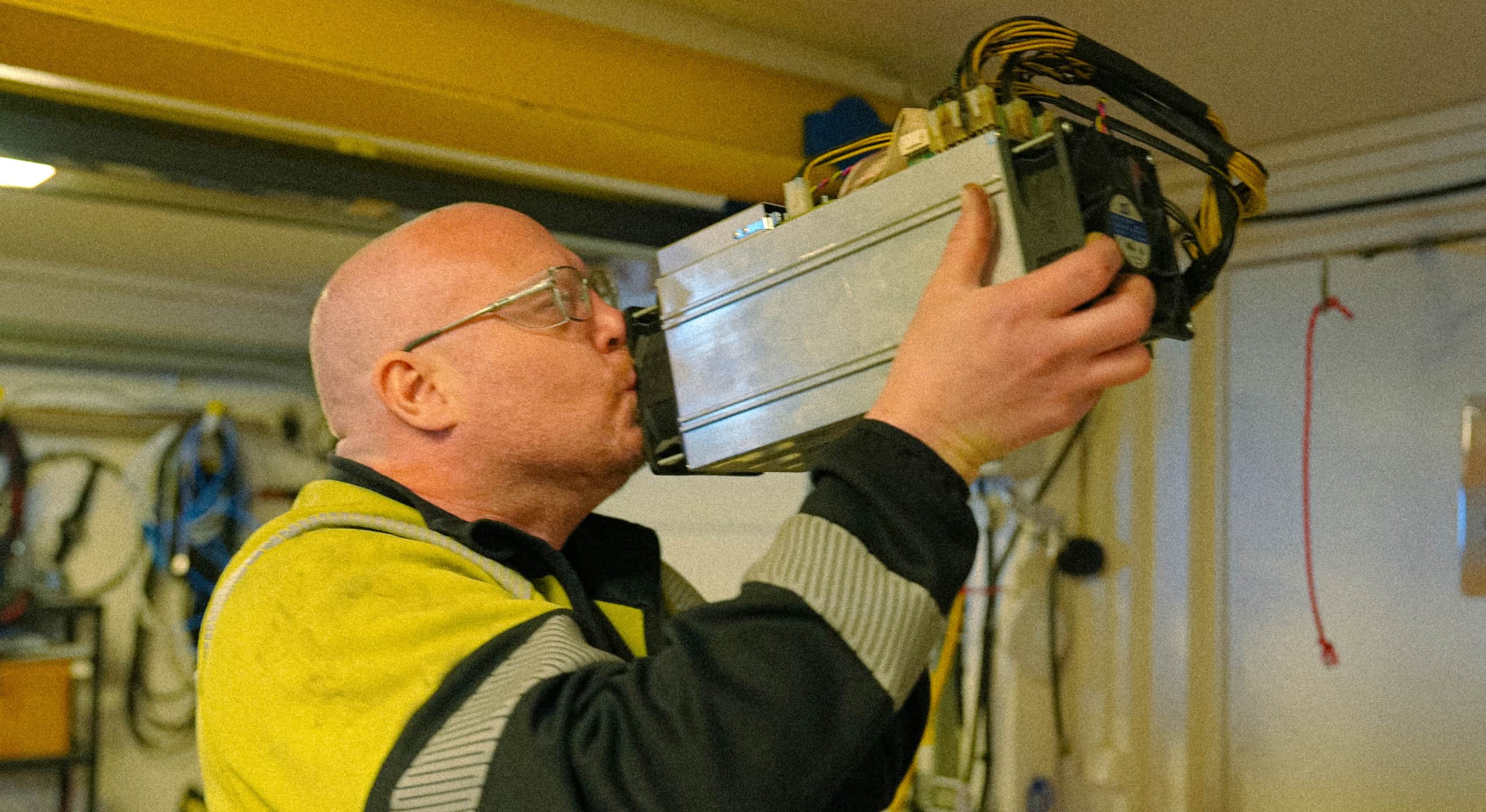 Mattias kissing one of his bitcoin miners in the garage