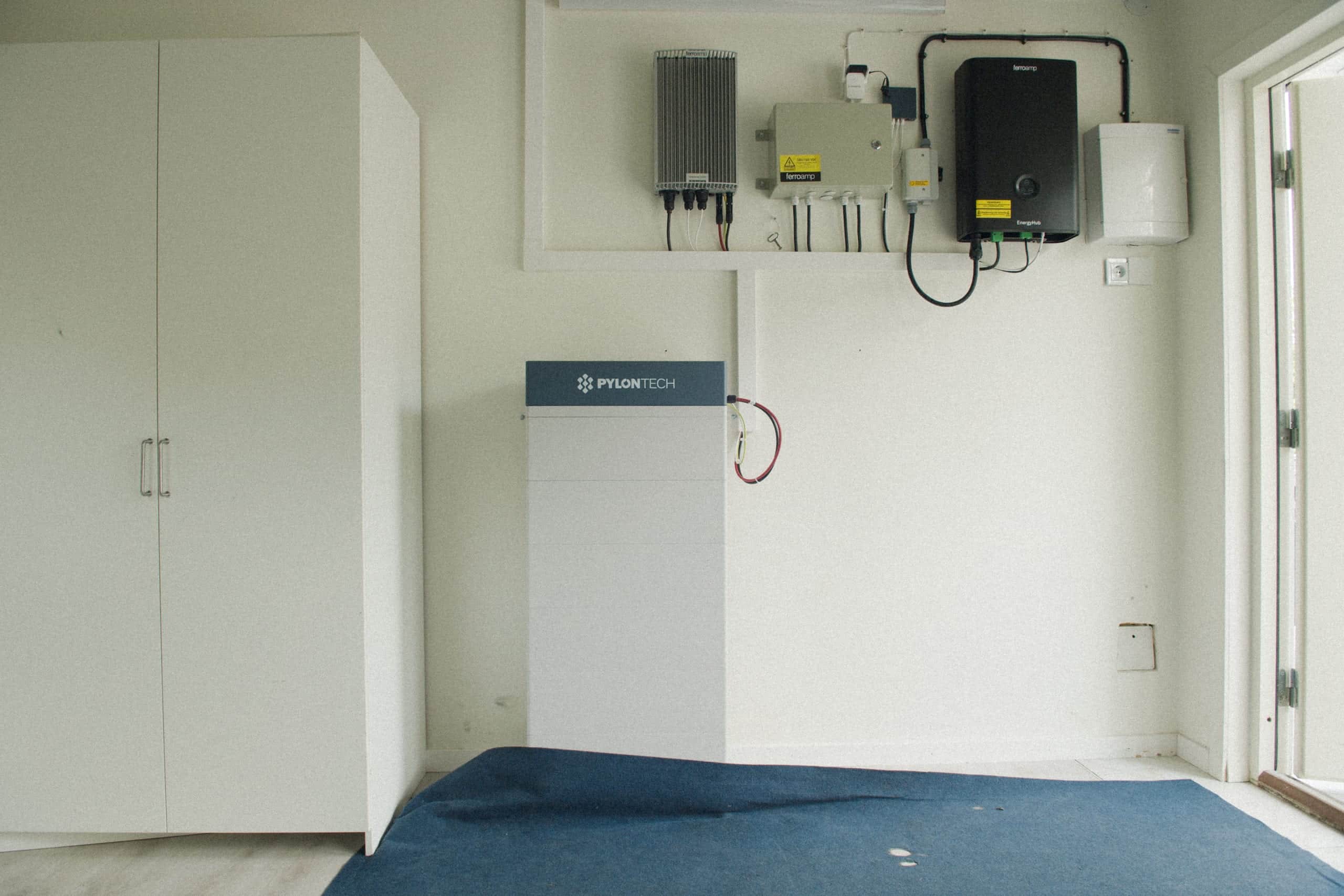Pylontech home battery mounted on a bedroom wall