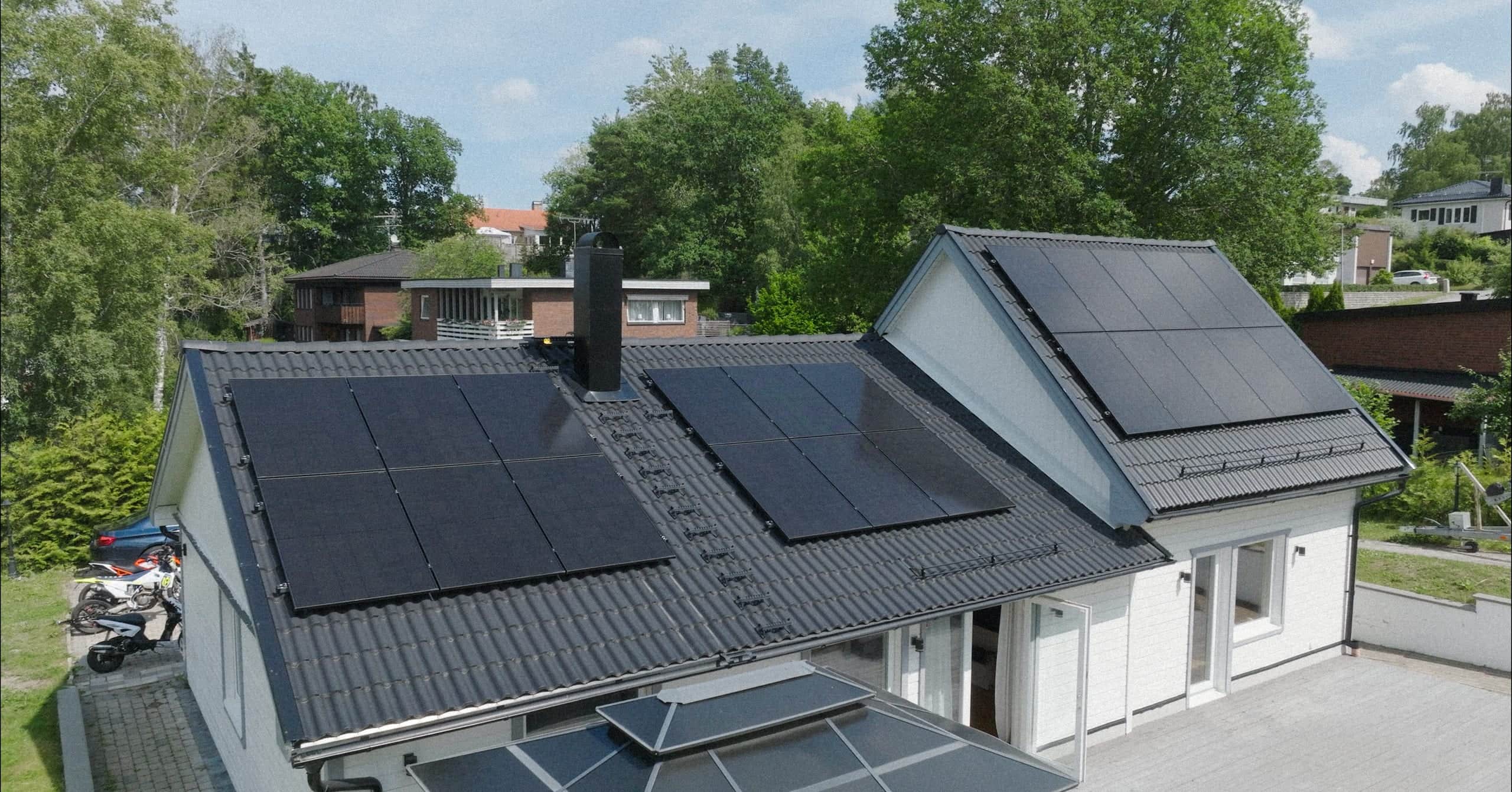 Drone view of solar panels across roofs, Elvy install