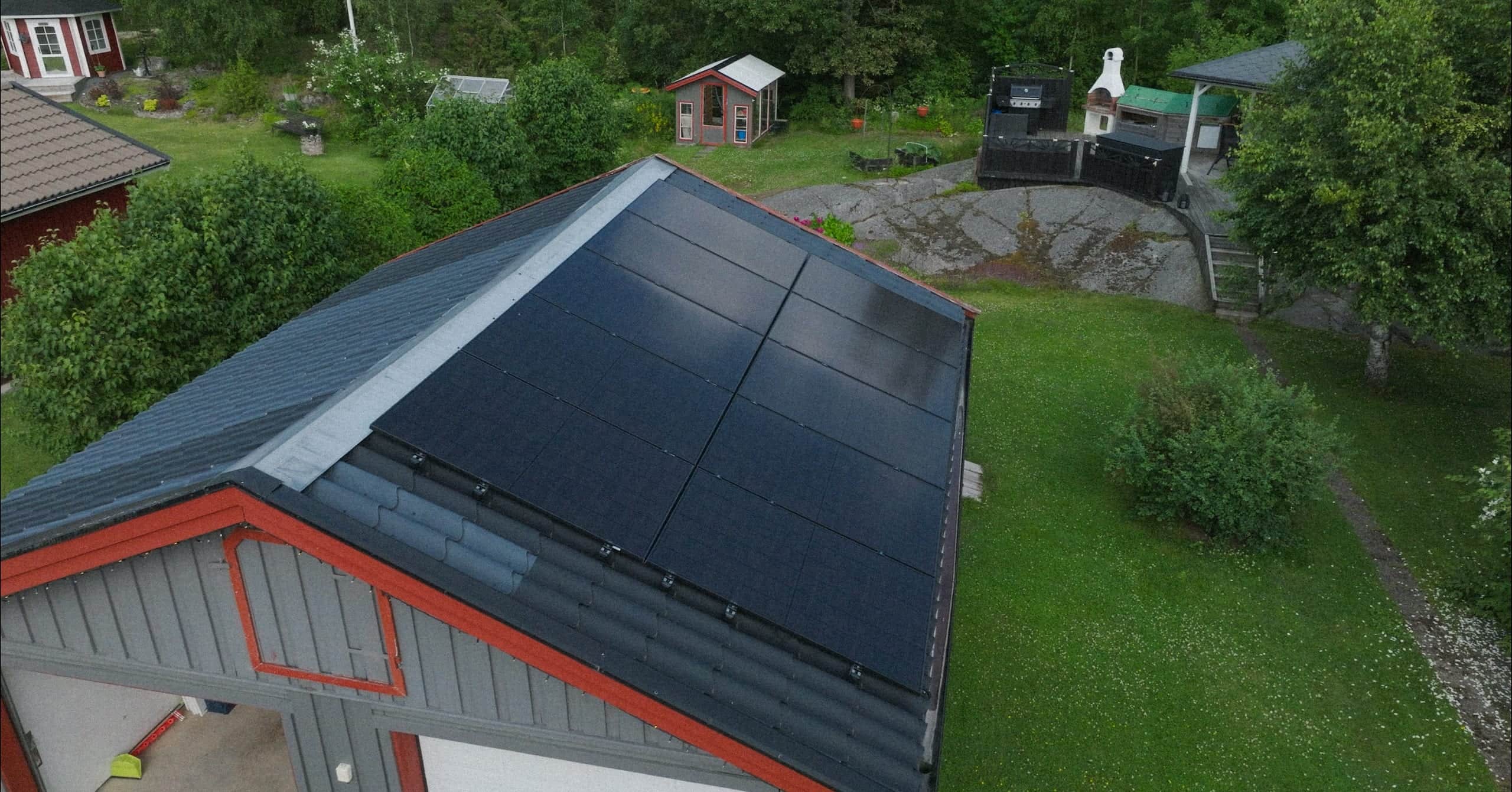 Aerial view of Elvy solar panels on a red house roof
