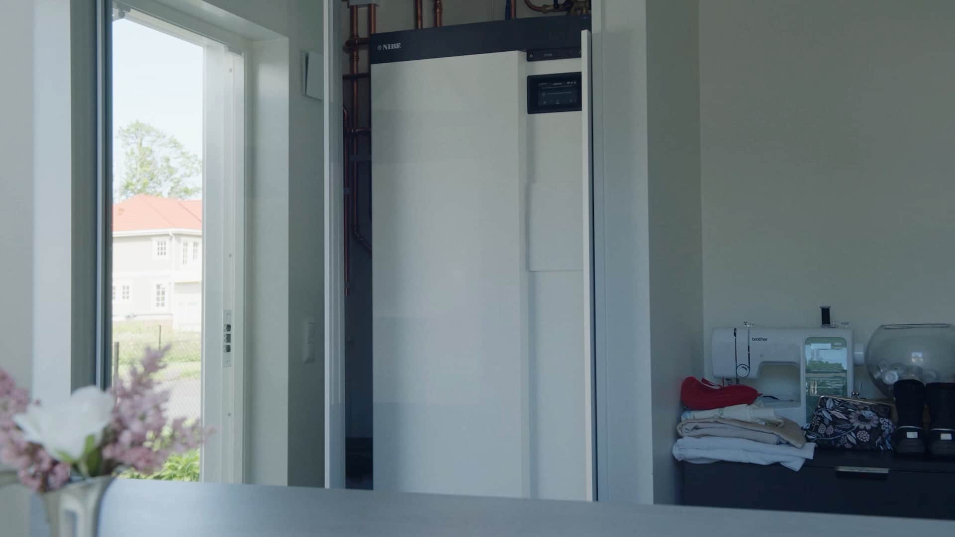 A NIBE heat pump installed in a bright utility room