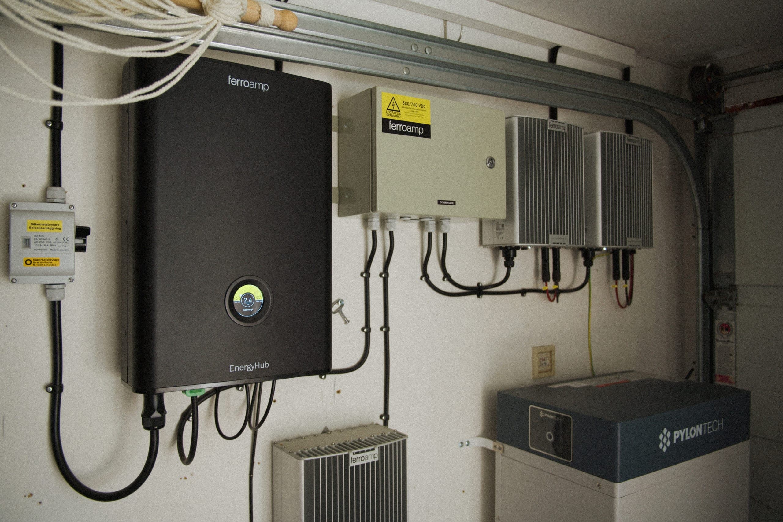En Elvy-växelriktare och ett Pylontech-hembatteri monterade på väggen i ett garage